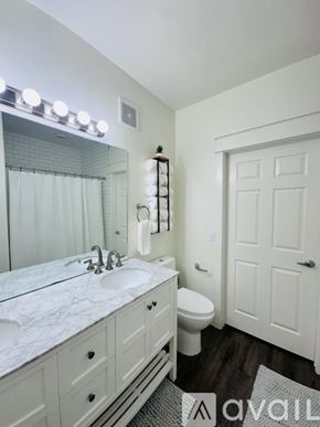 Fayetteville house for rent - A bedroom with a bed, nightstand, and lamp.