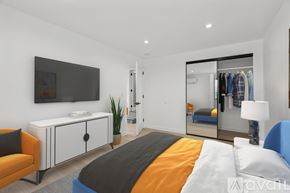Los Angeles apartment for rent - A bedroom with a bed, a chair, a cabinet, a mirror, and a television.