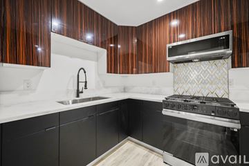 Los Angeles apartment for rent - A kitchen with a black oven and wooden cabinets.