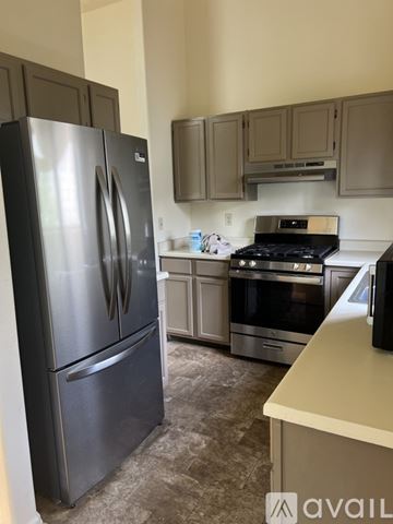 Colorado Springs house for rent - A kitchen with a black fridge and stove.