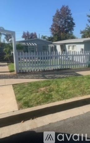El Cajon house for rent - A white picket fence in front of a house.