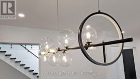 Toronto (St. Andrew-Windfields) house for rent - A chandelier with a circular frame and multiple light bulbs hangs from the ceiling.