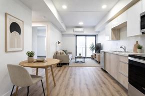 Saskatoon apartment for rent - A modern kitchen with a dining table and chairs.