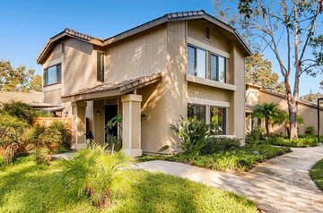San Diego house for rent - A modern house with a beige exterior and a well-manicured lawn.