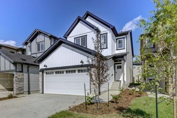 Edmonton apartment for rent - A modern house with a white garage door and a grey roof.
