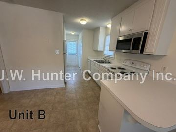 Wilson apartment for rent - A kitchen with white cabinets and appliances in a unit labeled B.