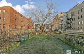 Washington house for rent - A pathway leads through a grassy area between two buildings.