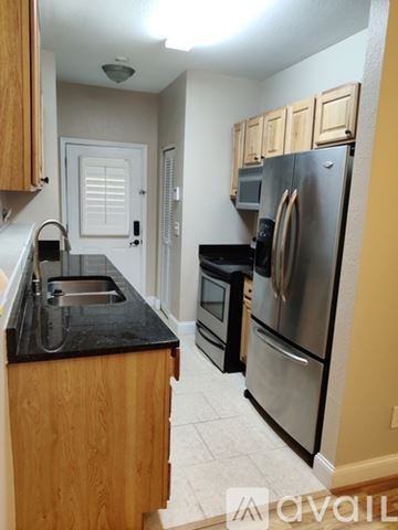 Ellijay house for rent - A kitchen with wooden cabinets and a stainless steel refrigerator.