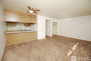 Pollock Pines apartment for rent - A kitchen with wooden cabinets and a black stove top oven.