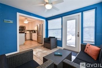 New Smyrna Beach townhouse for rent - A living room with a black couch and a fan.