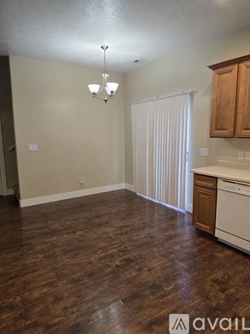 Riverton house for rent - A kitchen with wooden cabinets and a white stove top oven.