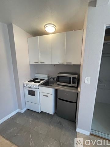 Sarasota apartment for rent - A kitchen with white appliances and cabinets.