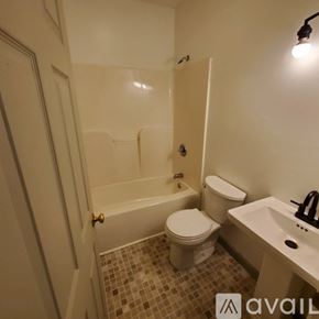 Williamsport apartment for rent - A bathroom with a toilet, sink, and bathtub.