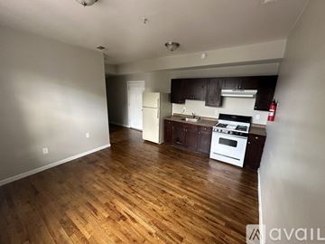 Newark apartment for rent - A kitchen with white appliances and wooden floors.
