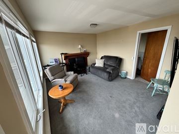 Vashon house for rent - A living room with a grey carpet and a wooden coffee table.