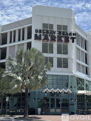 Delray Beach apartment for rent - A white building with a Delray Beach Market sign on it.