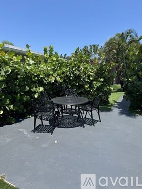 Delray Beach apartment for rent - A table and chairs set up on a patio.