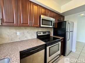 Delray Beach apartment for rent - A sign for Casa Tessa stands in a lush green yard.