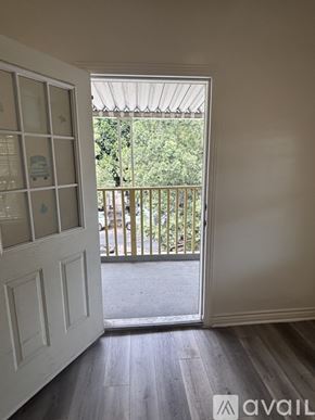 Los Angeles apartment for rent - A room with a white door and a balcony with a railing.