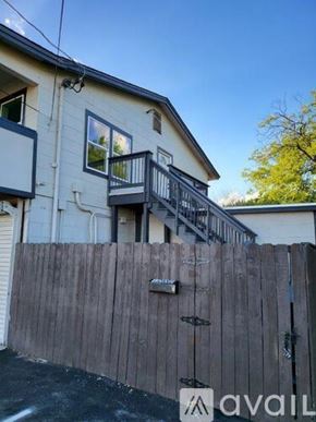 San Antonio apartment for rent - A house with a wooden fence and a balcony.