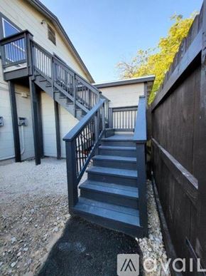 San Antonio apartment for rent - A set of stairs with a metal railing leads up to a building.