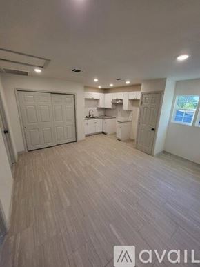 San Antonio apartment for rent - A spacious room with light wood flooring and white walls.