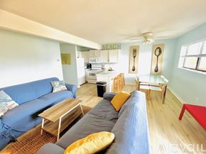 Ocean City apartment for rent - A living room with a couch, chairs, and a dining table.