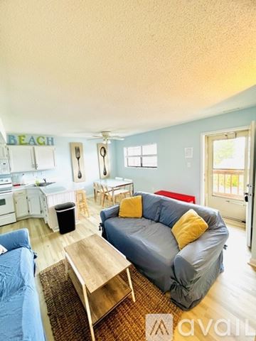 Ocean City apartment for rent - A living room with a couch and a table.