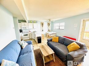 Ocean City apartment for rent - A living room with a blue couch and a grey couch.