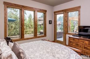 Bend townhouse for rent - A bedroom with a large bed and a television.