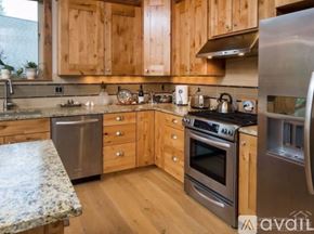 Bend townhouse for rent - A kitchen with wooden cabinets and stainless steel appliances.