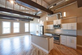Pittsfield apartment for rent - an empty kitchen with a large island in the middle of it