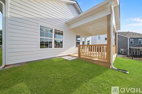 Knoxville house for rent - A house with a white exterior and a wooden deck.