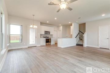Mansfield house for rent - A spacious living room with a fan and lighting fixtures.