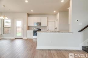 Mansfield house for rent - A modern kitchen with white cabinets and a wooden floor.