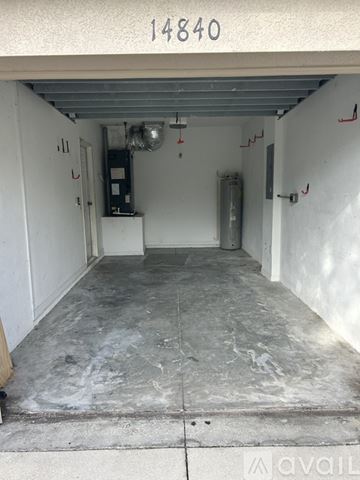 Lakewood Ranch house for rent - A kitchen with a black fridge and white cabinets.