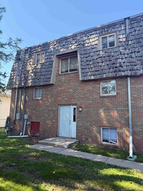 Moorhead apartment for rent - A red brick house with a white door and windows.