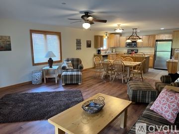 Arkdale apartment for rent - A living room with a ceiling fan and a dining table with chairs.