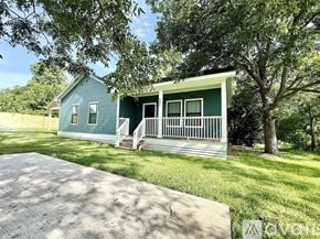 Brenham house for rent - A green house with a porch and a driveway in front.