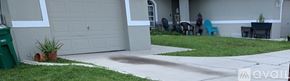 Cape Coral house for rent - A house with a grey garage door and a white wall.