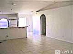 Cape Coral house for rent - A spacious room with a doorway leading to another room.