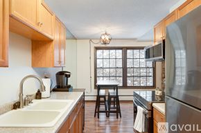 Hopkins condo for rent - A kitchen with wooden cabinets and a sink.