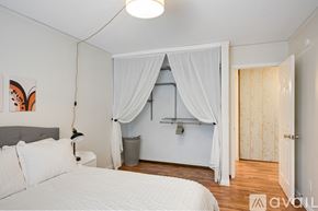 Hopkins condo for rent - A bedroom with a bed, a canopy bed with a canopy, and a painting on the wall.