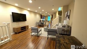 Irvine condo for rent - A bedroom with a large bed and a flat screen TV on a wooden stand.