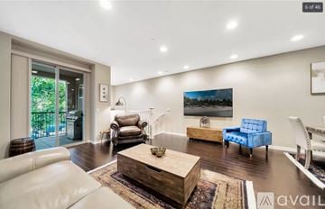 Irvine condo for rent - A living room with a white couch, a blue chair, and a painting on the wall.