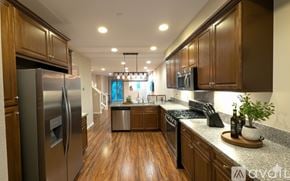 Irvine condo for rent - A sunny day at a residential complex with a pool and palm trees.