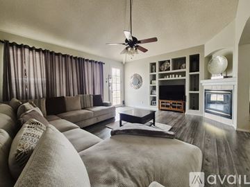 El Paso house for rent - A living room with a grey sofa and a black coffee table.