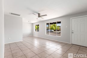 Mesa house for rent - A spacious room with a ceiling fan and tiled flooring.