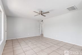 Mesa house for rent - A room with a ceiling fan and tiled floor.