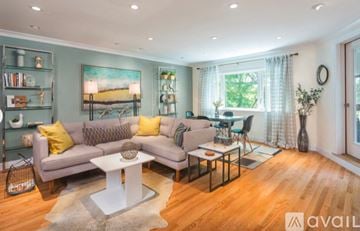 Brookline apartment for rent - A living room with a grey sofa and a white coffee table.